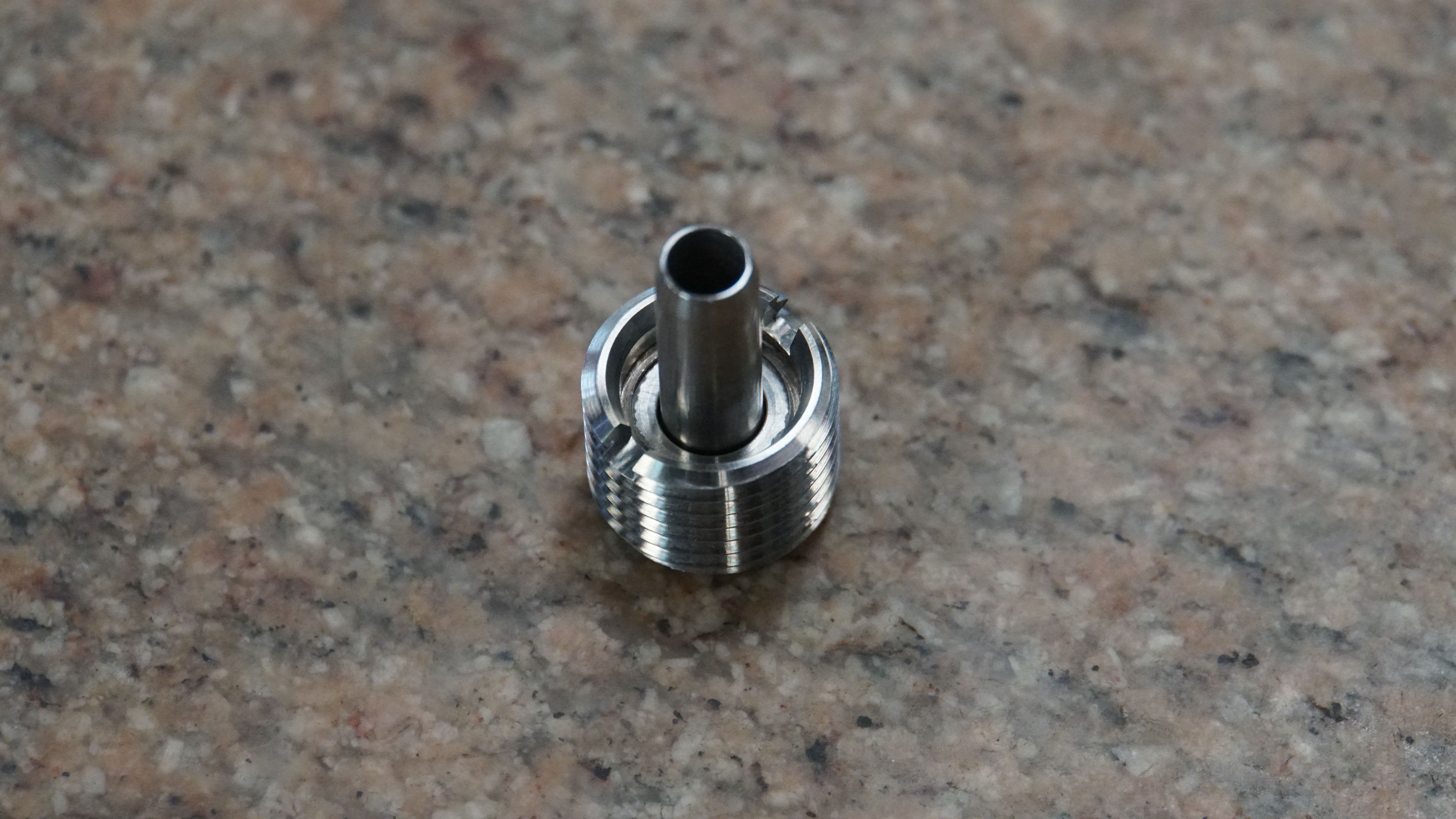 Finished modular coolant nozzle prototype — SS 316 threaded body with replaceable 15-5 PH H1025 coolant tube