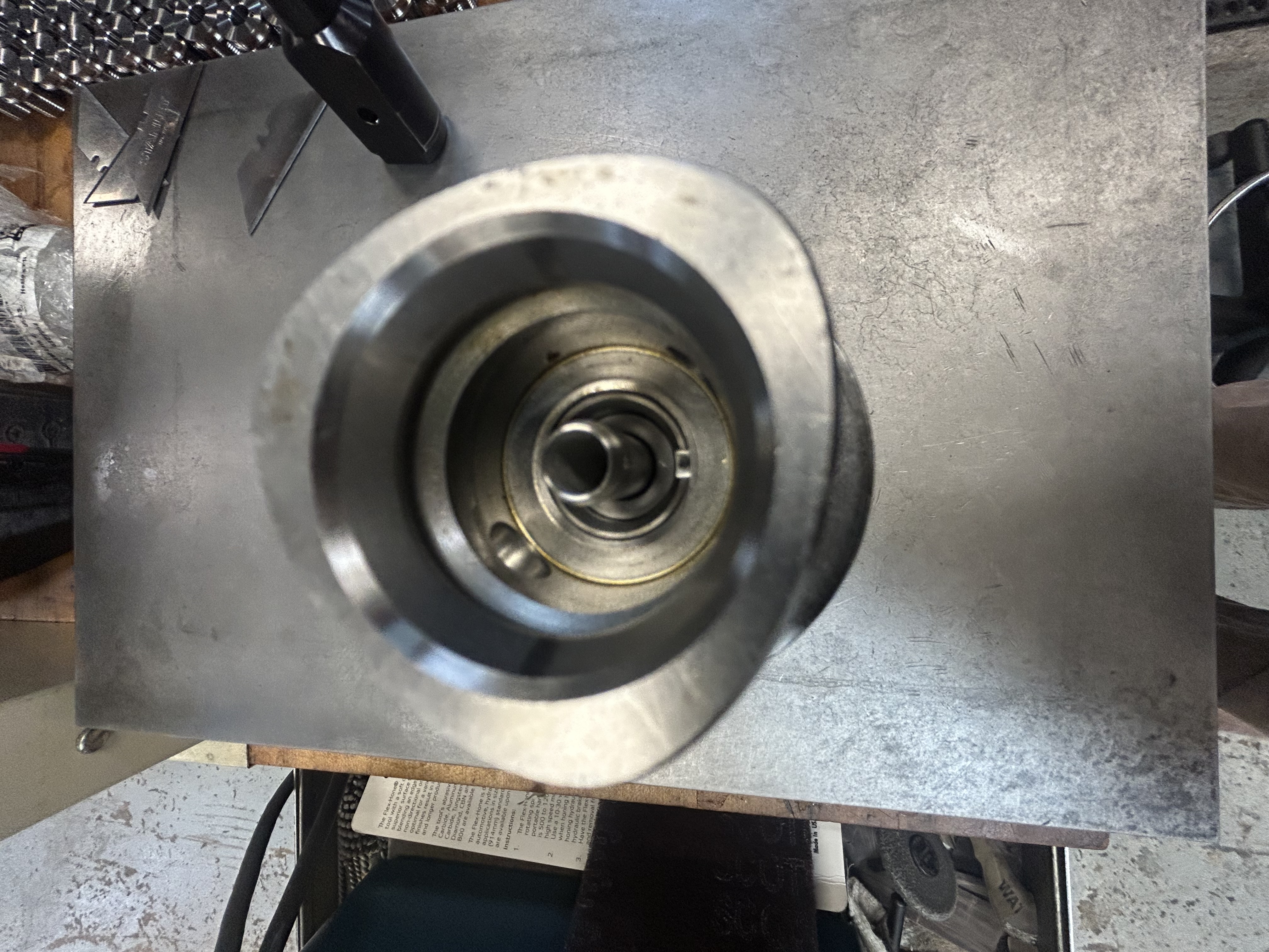 Redesigned nozzle installed in Mazak tool holder — modular tube protrudes through the threaded body, sealed with O-rings and retained by internal spiral clip ring